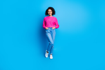 Full size photo of nice young girl posing empty space wear pink sweater isolated on blue color background