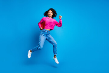 Full size photo of pretty young girl jump worried running wear trendy pink outfit isolated on blue color background