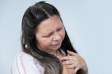caucasian mature woman experiences sudden chest pain behind sternum, clutching chest, Arterial...