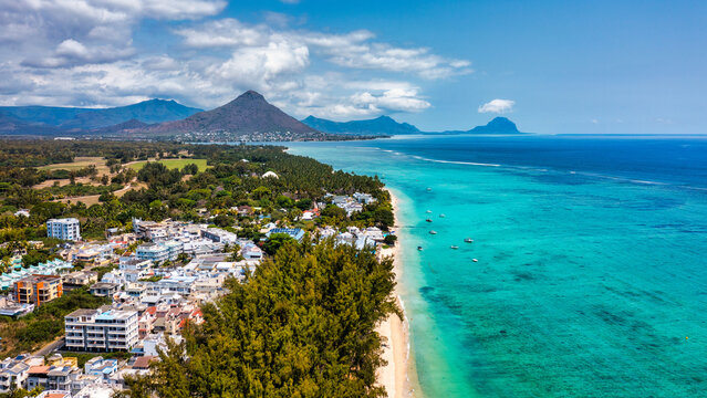 Beach of Flic en Flac with Piton de la Petite Riviere Noire Mauritius. Beautiful Mauritius Island with gorgeous beach Flic en Flac, aerial view from drone. Flic en Flac Beach, Mauritius Island.