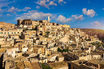 Obraz premium Panoramic view of the ancient town of Matera (Sassi di Matera) in a beautiful autumn day, Basilicata, southern Italy. Stunning view of the village of Matera. Matera is a city on a rocky outcrop.