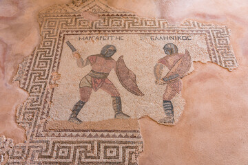 A mosaic of two men fighting with swords. The men are wearing red and black. The mosaic is on a...