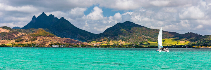 Beautiful catamaran in the paradise turquoise lagoon of the east coast of Mauritius. View of the lagoon of Mauritius in the Indian Ocean. © daliu