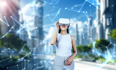 Female standing and wearing white VR headset and white sleeveless connect metaverse, future...