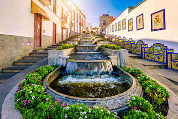 Famous Paseo de Canarias street on Firgas, Gran Canaria, Canary Islands, Spain. Fountain of natural...