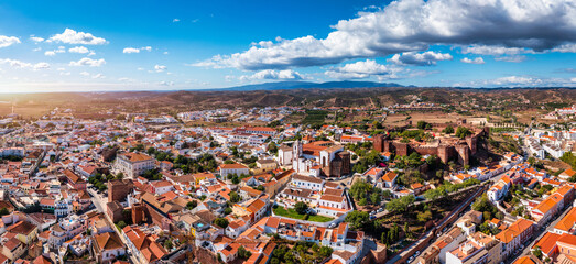 View of Silves town buildings with famous castle and cathedral, Algarve region, Portugal. Walls of...