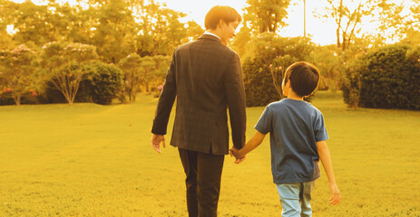 Visionary and eco conscious businessman father guide his son to the bright future with sunset...