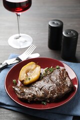 Delicious roasted beef meat and caramelized pear served on grey wooden table