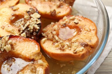 Delicious baked quinces with nuts and honey in bowl, closeup