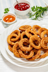 deep fried crispy onion rings on white plate