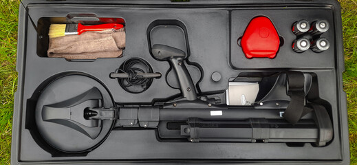 A metal detector used to search for mines. Cleaning of territories contaminated by land mines. The process of humanitarian demining.