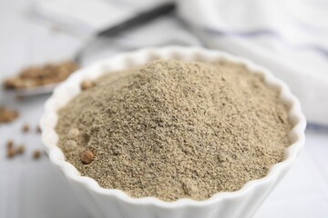 Ground pepper on white tiled table, closeup
