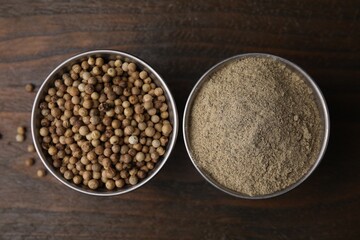 Ground pepper and peppercorns on wooden table, flat lay