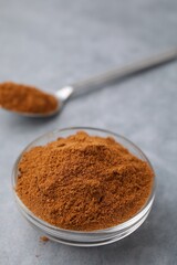 Ground red pepper on grey table, closeup