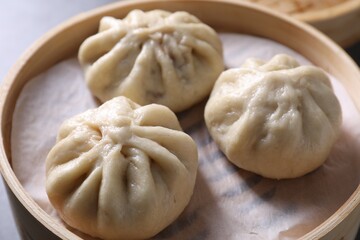 Delicious bao buns (baozi) on table, closeup