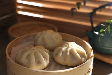 Delicious bao buns (baozi) on table, closeup