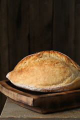 Freshly baked sourdough bread on wooden table