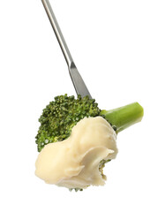 Tasty fondue. Fork with broccoli and melted cheese isolated on white