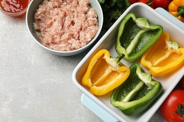 Making stuffed peppers. Vegetables and ground meat on grey table, flat lay. Space for text
