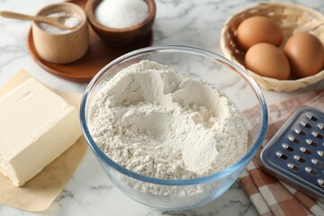 Making shortcrust pastry. Different ingredients for dough and grater on white marble table