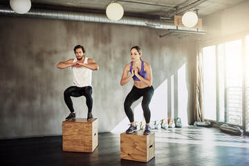 Jump, exercise and couple in gym with box, power and training at workout challenge together. Man,...