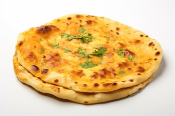 A large, golden brown flatbread with a green herb on top. The bread is placed on a white background