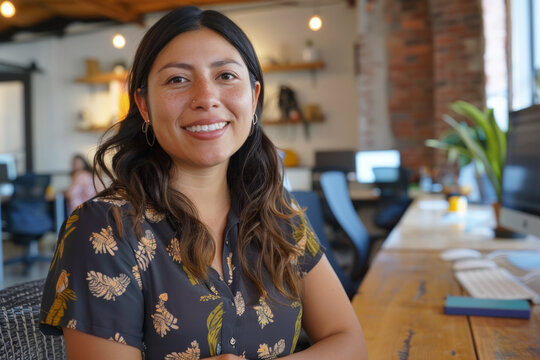 A Hispanic woman manager, fostering teamwork and inclusivity in a vibrant startup office environment, offering mentorship and support to her diverse team members.