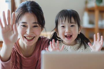 A smiling Japanese single mother and her child wave happily during a video call through a laptop at home. Their faces glow with excitement as they interact with loved ones, cherishing moments of
