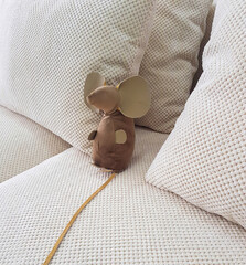 Mouse - a soft toy among pillows