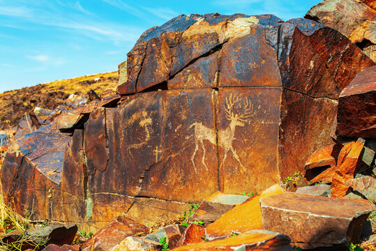 Ancient cave paintings on rocks in Karasay gorge, Taraz, Zhambyl Region, Kazakhstan. Petroglyphs Bronze Age and Iron Age rock art