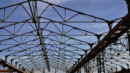 metallic geometric structure of beams against the sky