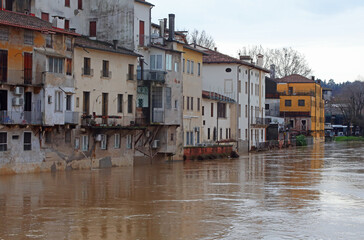 Fototapeta na wymiar River overflowed during a city flood and the homes of the population lapped by the water