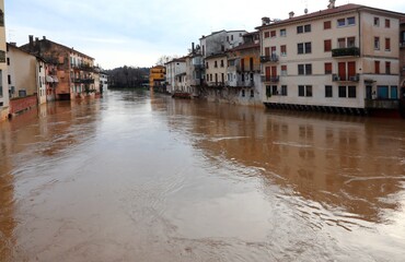 River overflowed during a city flood and the homes of the population lapped by the muddy water
