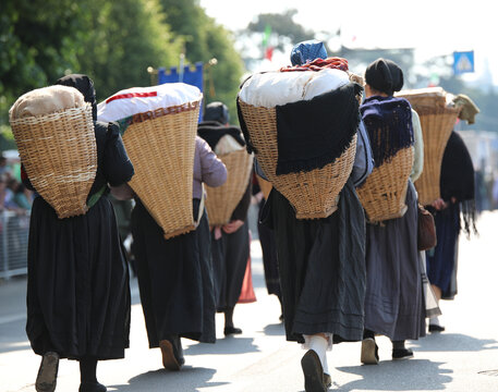 Carnic Women Carrying Supplies During World War I Reenactment with backpack called GERLA in italian language