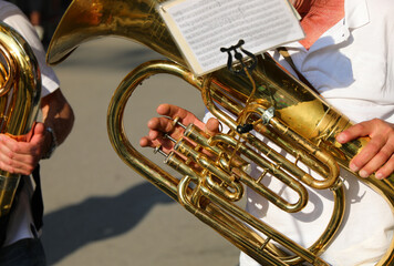 hand playing a brass instrument during a band parade