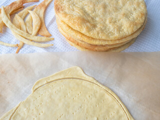 Cooking a shortcrust puff pastry Napoleon cake with a pile of baked golden browned thin buttery layers, dough scraps, and a raw layer rolled out on baking paper on a white waffle towel.