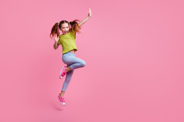 Full length photo of lovely little girl dancing have fun dressed stylish green garment isolated on...