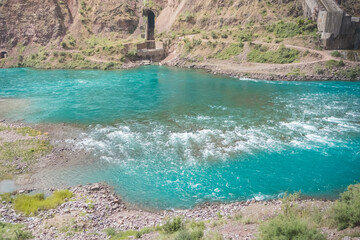 Nurek hydroelectric station in Tajikistan with an embankment dam and engineering structures and water discharge