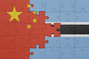 puzzle with the colourful national flag of botswana and flag of china .