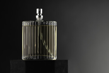 Luxury men`s perfume in bottle against grey background, space for text