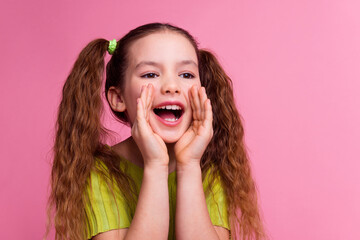 Photo portrait of cute little girl scream share secret dressed stylish green clothes isolated on...