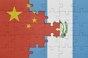 puzzle with the colourful national flag of guatemala and flag of china .