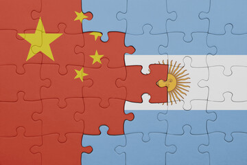 puzzle with the colourful national flag of argentina and flag of china .