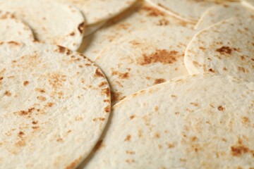 Many tasty homemade tortillas as background, closeup
