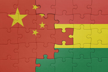 puzzle with the colourful national flag of bolivia and flag of china .