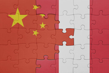 puzzle with the colourful national flag of peru and flag of china .