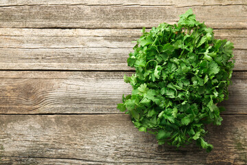 Fresh coriander on wooden table, top view. Space for text