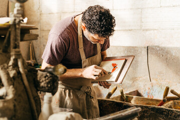 Factory Worker Inspects Colorful Cement Tiles With Trencadis Technique in Workshop