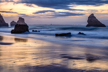 Sunrise at Praia Dona Ana beach, with its spectacular sea stacks and cliffs in Lagos, Algarve,...