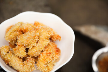 golden, crispy fried chicken pieces in bubbling oil, symbolizing indulgence and temptation